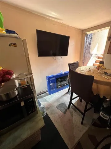 a utility room with dryer washer and stair