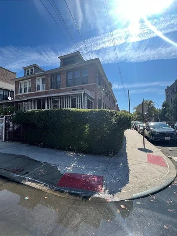 a view of a brick house with a yard