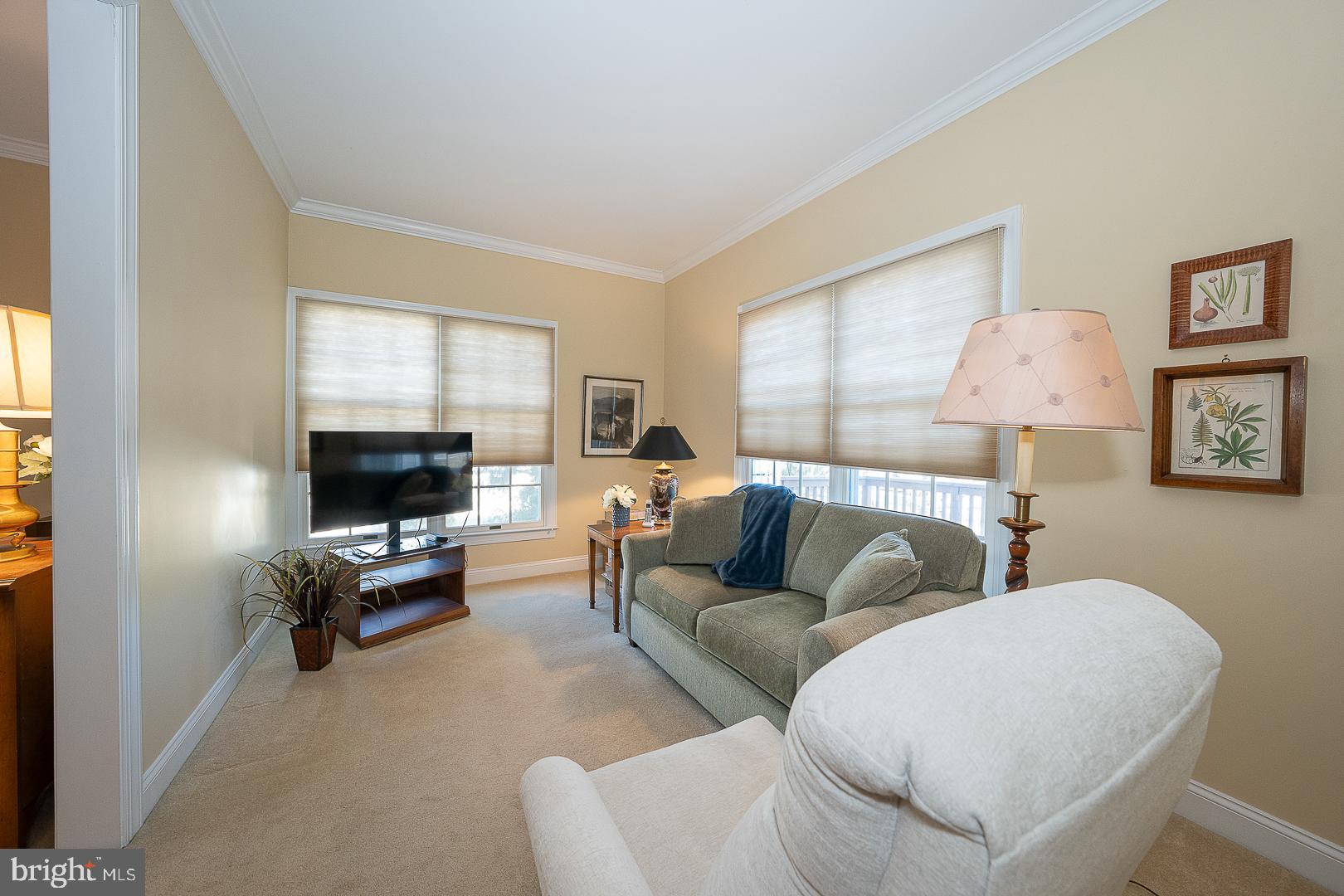 48 Longview Circle, Unit 48 Berwyn, PA 19312 - Photo 11 of 36 a living room with furniture and a flat screen tv