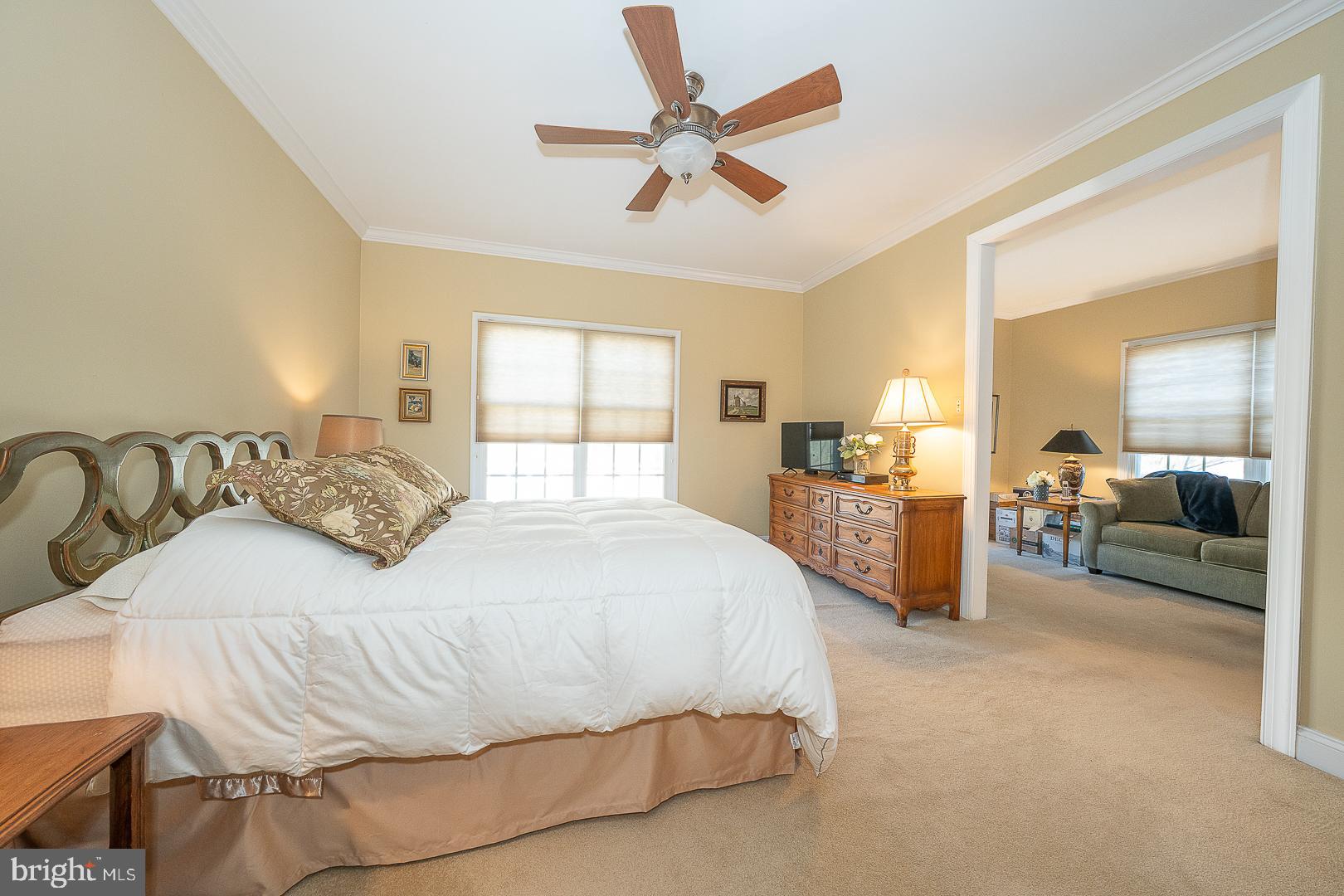 48 Longview Circle, Unit 48 Berwyn, PA 19312 - Photo 12 of 36 a bedroom with a bed a couch and a chandelier