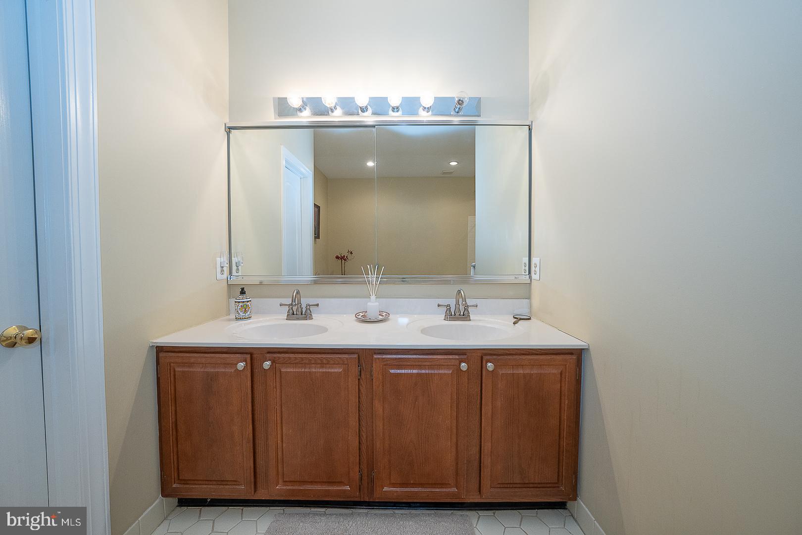 48 Longview Circle, Unit 48 Berwyn, PA 19312 - Photo 16 of 36 a bathroom with a double vanity sink and a mirror
