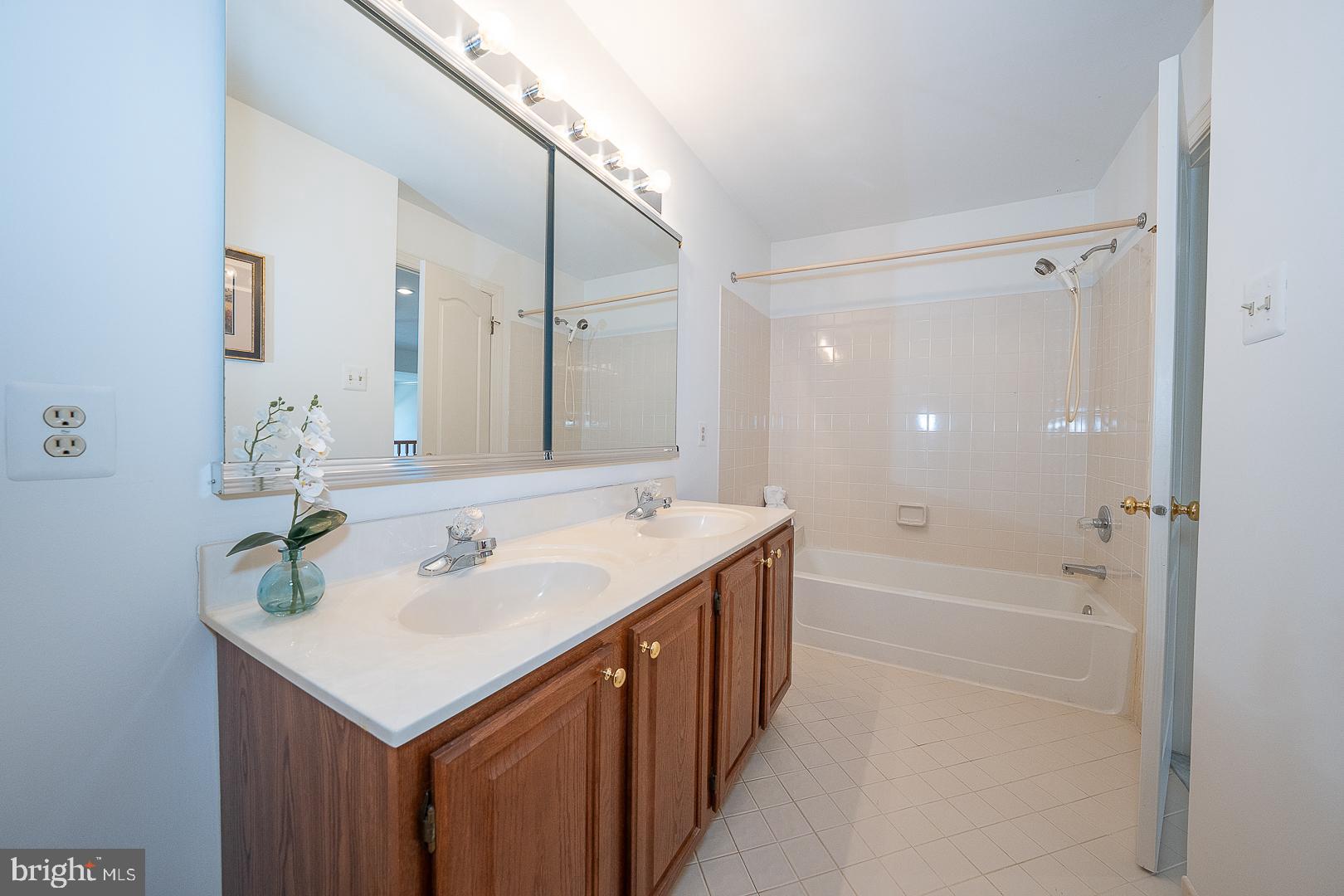 48 Longview Circle, Unit 48 Berwyn, PA 19312 - Photo 21 of 36 a bathroom with a sink double vanity granite tub shower and a mirror