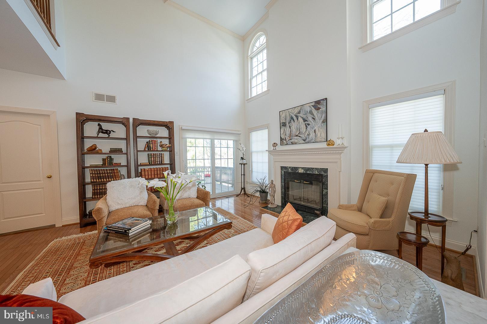 48 Longview Circle, Unit 48 Berwyn, PA 19312 - Photo 4 of 36 a living room with furniture a lamp wooden floor and a fireplace