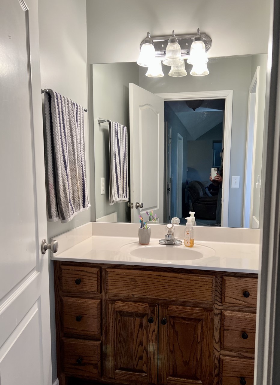 1004 Roland Court Cottontown, TN 37048 - Photo 13 of 22 a bathroom with a granite countertop sink and a mirror