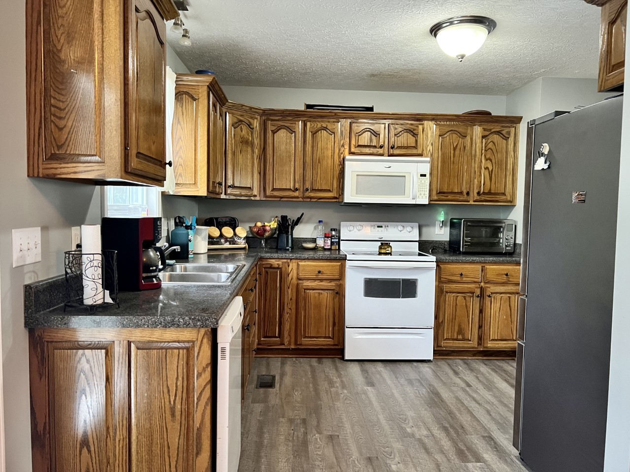 1004 Roland Court Cottontown, TN 37048 - Photo 4 of 22 a kitchen with stainless steel appliances granite countertop a stove a sink dishwasher and a refrigerator