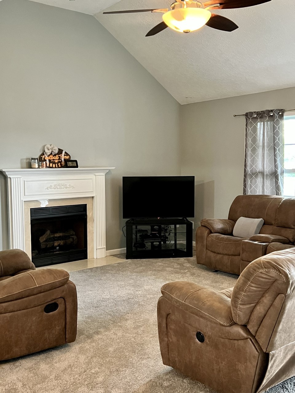 1004 Roland Court Cottontown, TN 37048 - Photo 8 of 22 a living room with furniture a flat screen tv and a fireplace