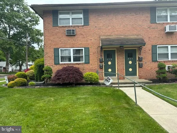 a view of a house with a yard and plants