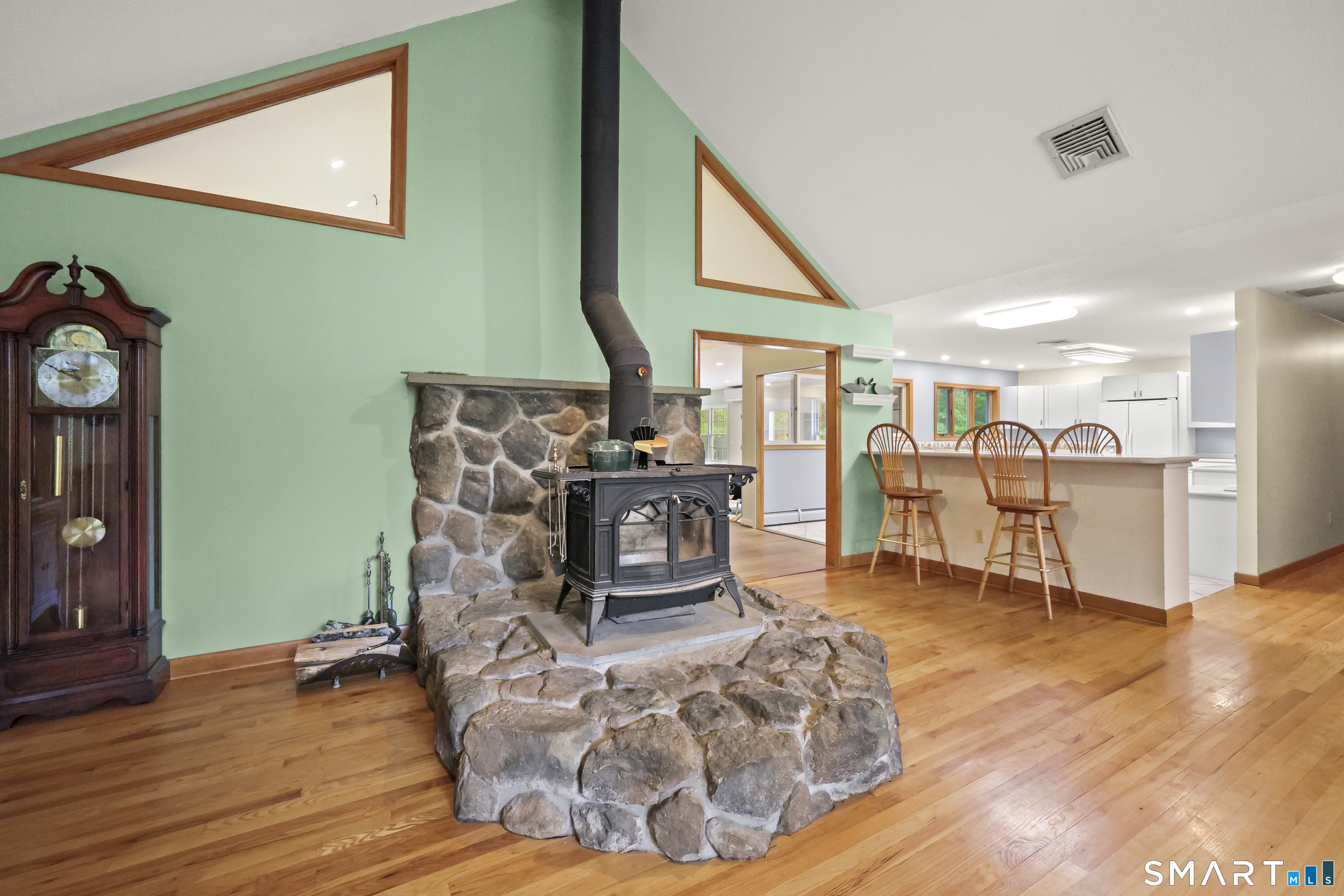 96 Spak Road Willington, CT 06279 - Photo 9 of 40 Wood stove set upon a fieldstone hearth anchors the living room with warmth & rustic elegance.
