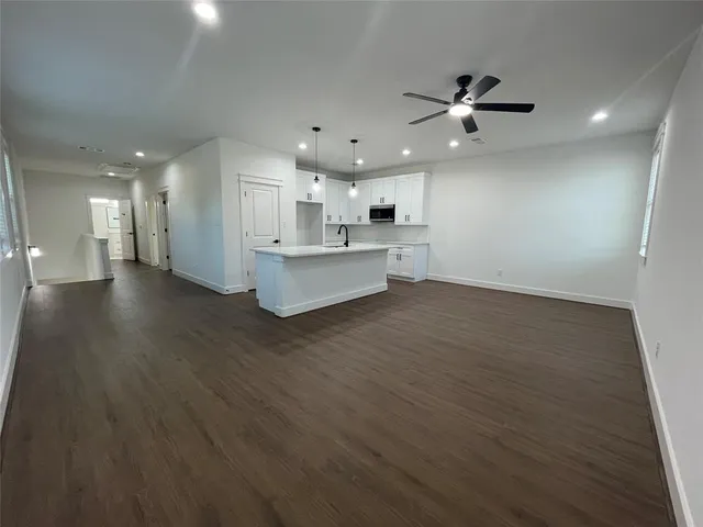 a view of kitchen with cabinets and wooden floor