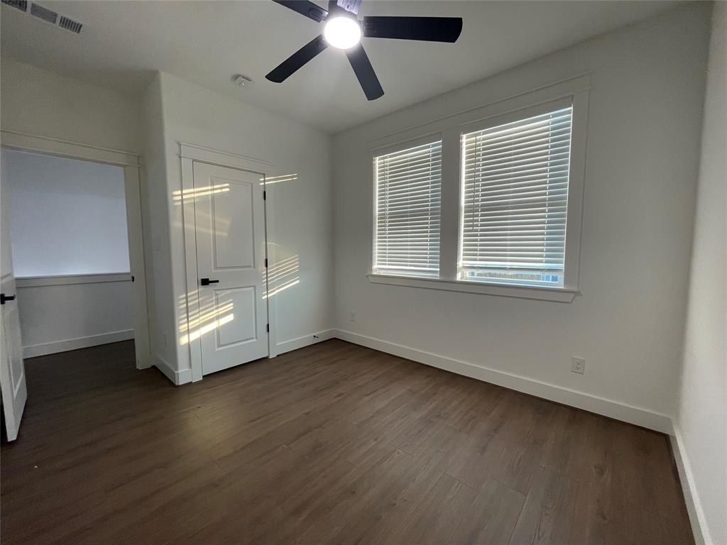 2725 1st Avenue Dallas, TX 75210 - Photo 16 of 29 a view of an empty room with wooden floor and a window