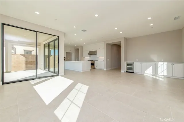 a large white room with a large window and table