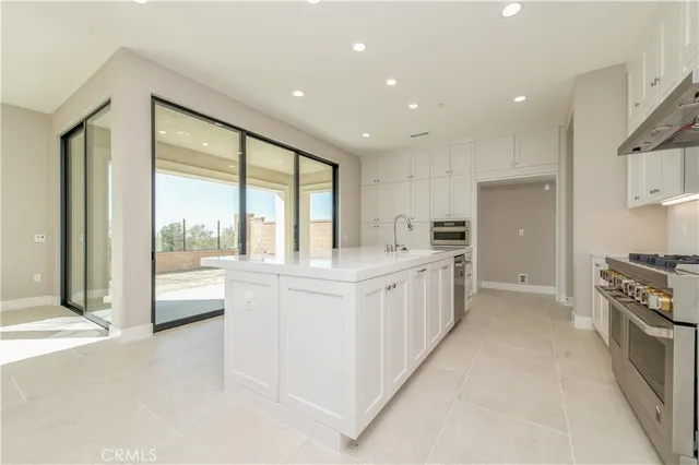 a kitchen with white cabinets and white appliances