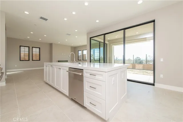 a large white kitchen with a large window