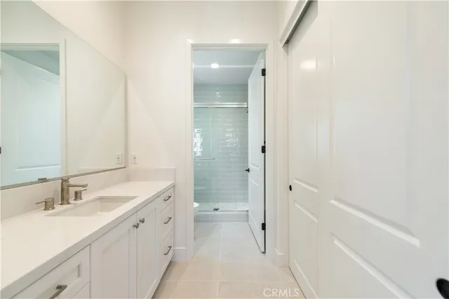 a bathroom with a sink a mirror and a shower