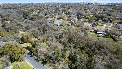 an aerial view of residential house with space and trees all around