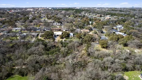an aerial view of town with residential houses and trees