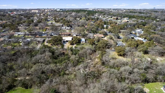 an aerial view of town with residential houses and trees