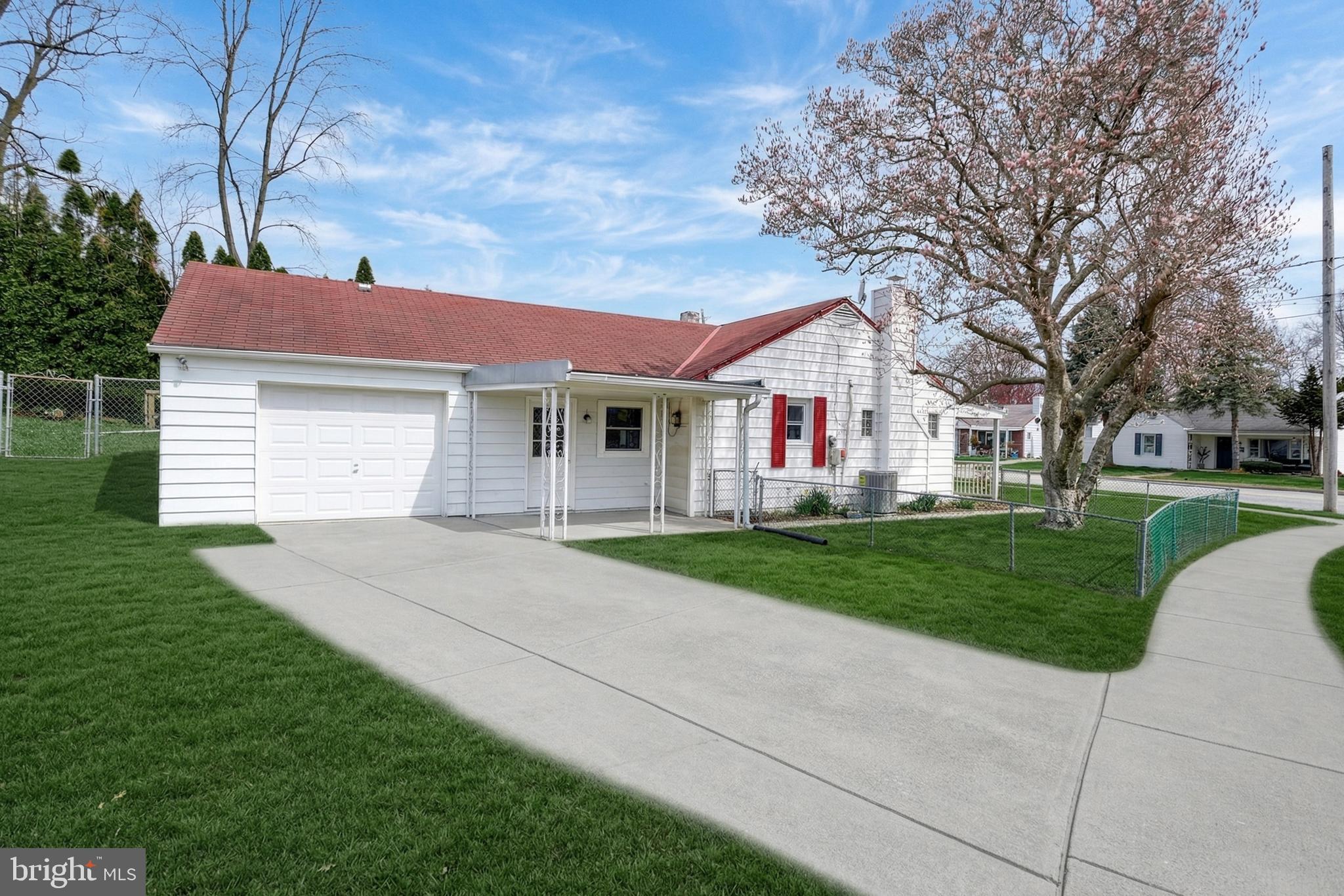 1400 Simpson Ferry Road New Cumberland, PA 17070 - Photo 1 of 31 a front view of a house with a yard and garage