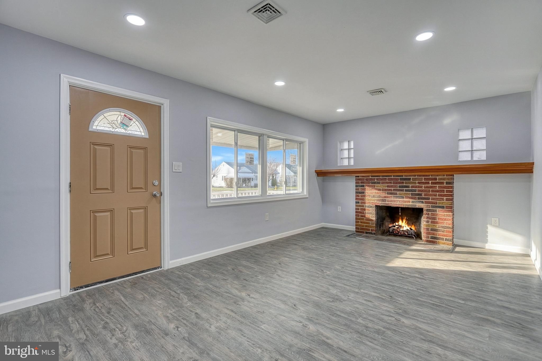 1400 Simpson Ferry Road New Cumberland, PA 17070 - Photo 11 of 31 an empty room with windows and fireplace