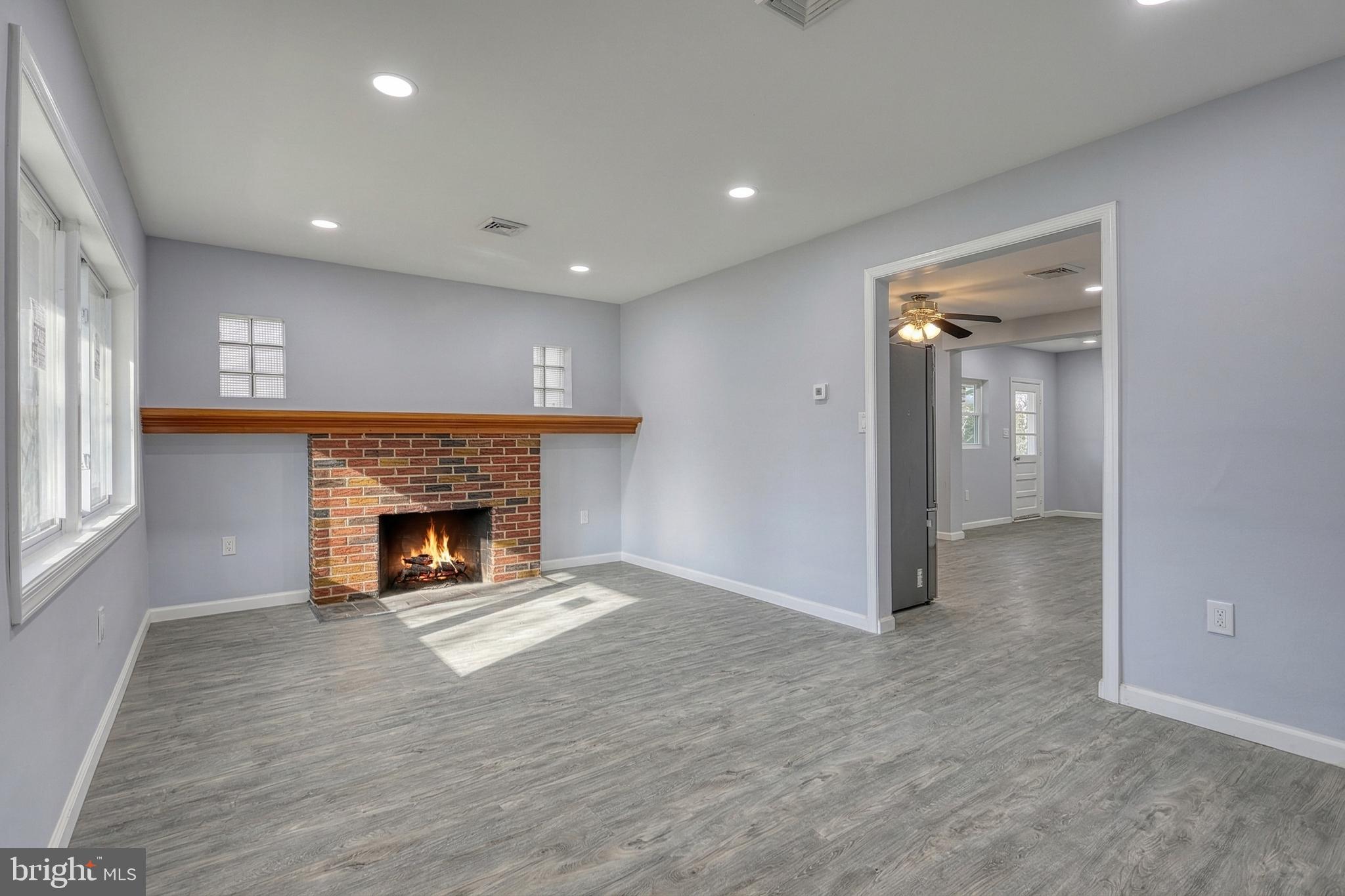 1400 Simpson Ferry Road New Cumberland, PA 17070 - Photo 12 of 31 an empty room with wooden floor and fireplace