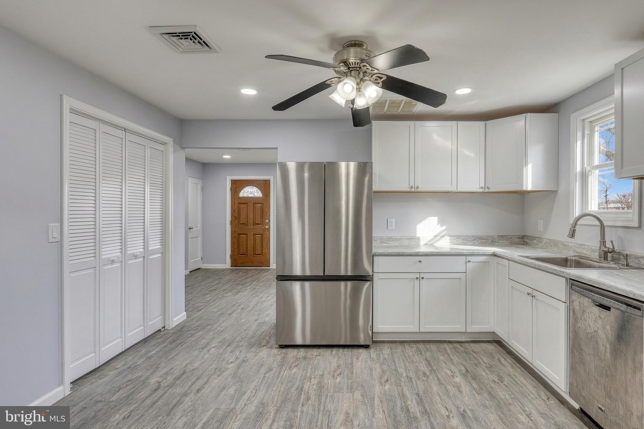 1400 Simpson Ferry Road New Cumberland, PA 17070 - Photo 15 of 31 a kitchen with stainless steel appliances granite countertop a refrigerator a sink and white cabinets