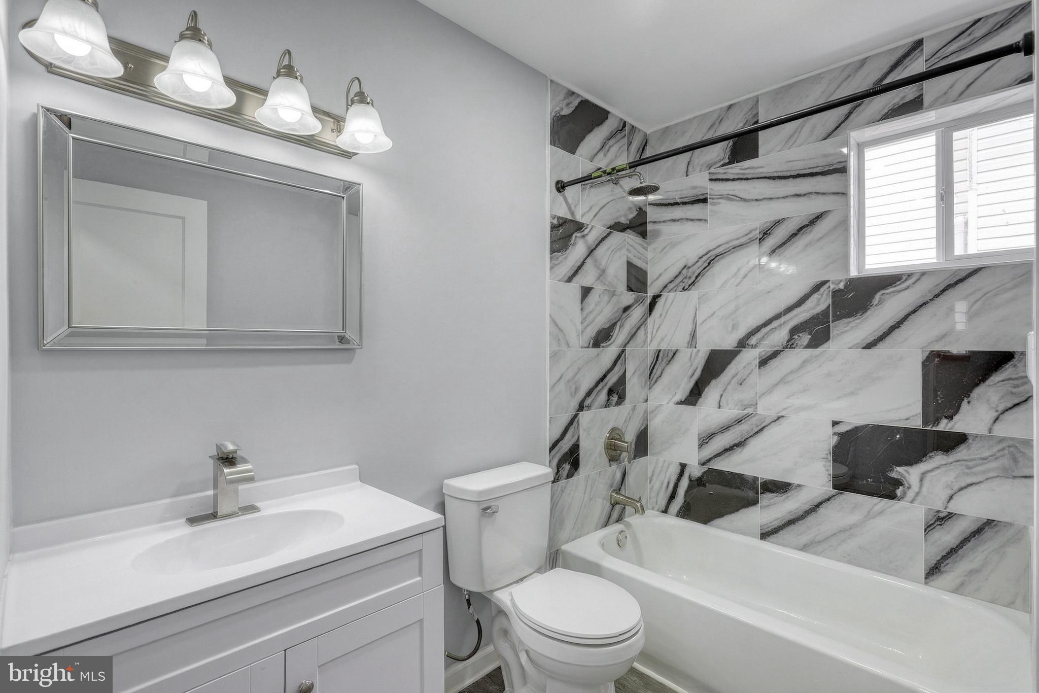 1400 Simpson Ferry Road New Cumberland, PA 17070 - Photo 25 of 31 a bathroom with a sink vanity mirror and toilet
