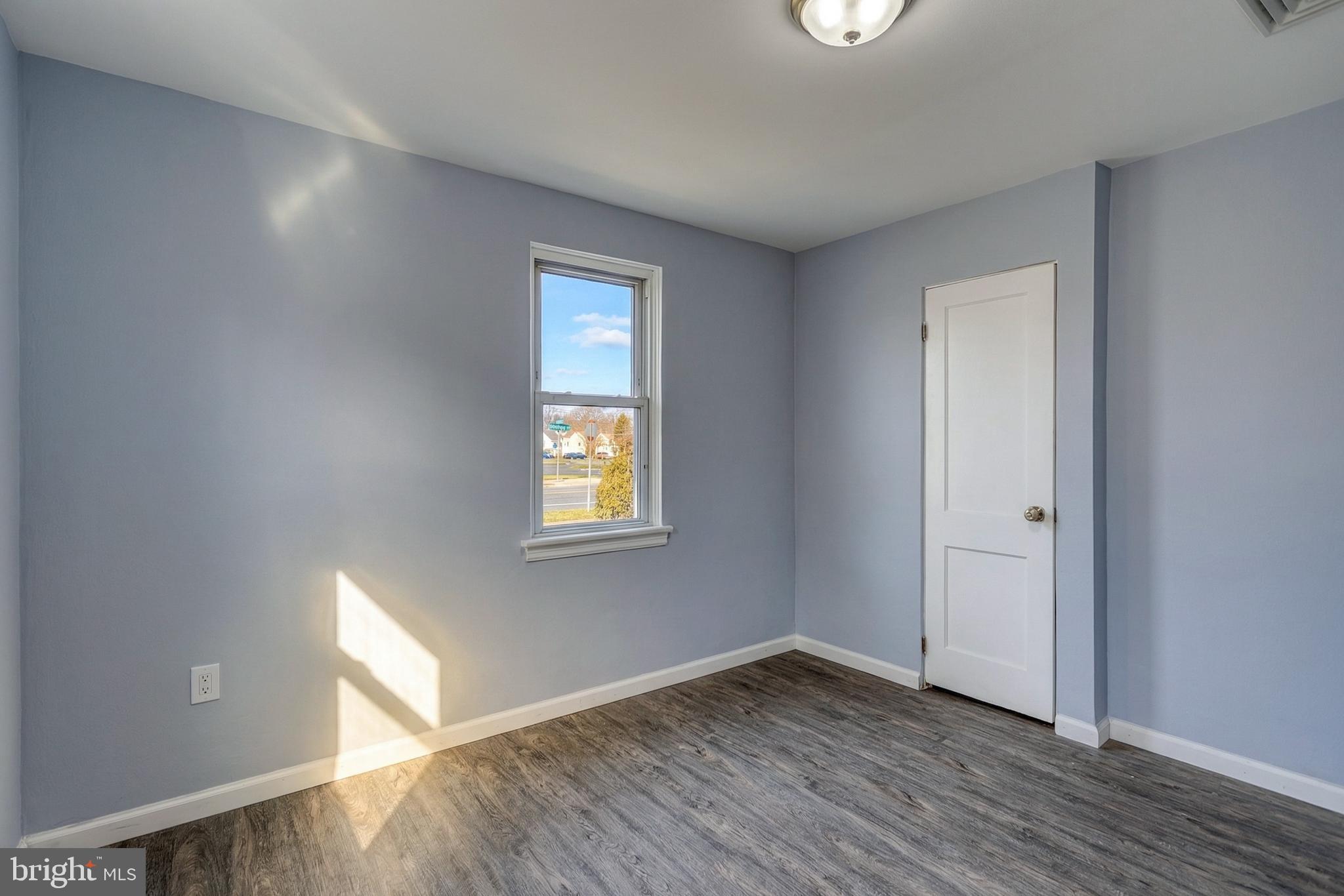 1400 Simpson Ferry Road New Cumberland, PA 17070 - Photo 29 of 31 a view of an empty room with wooden floor and a window