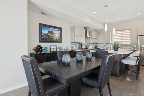 a dining room with furniture a window and wooden floor