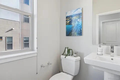 a bathroom with a toilet a sink and a mirror