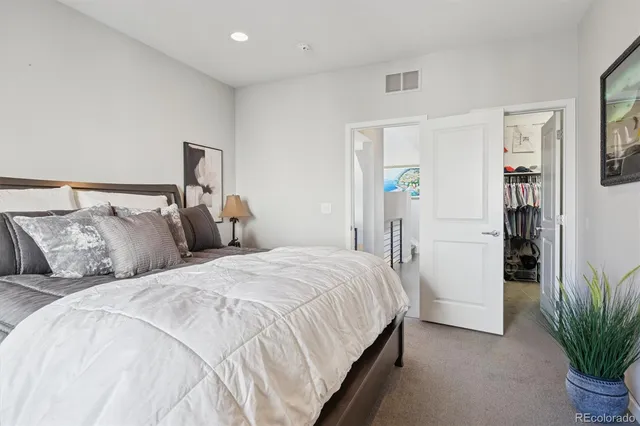 a bed room with bed and a potted plant