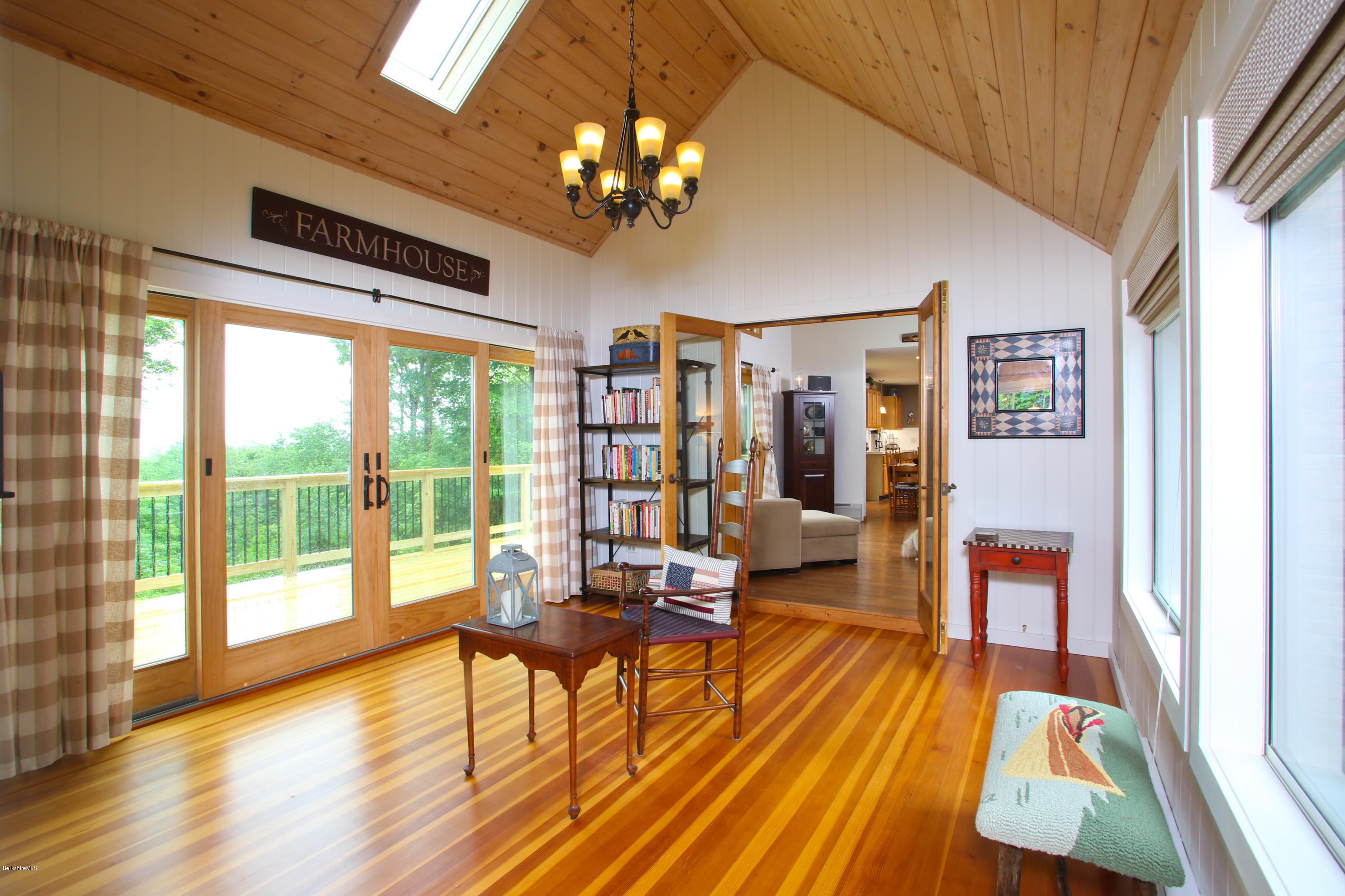 263 Harrington Road Otis, MA 01253 - Photo 17 of 33 a living room with furniture and a chandelier
