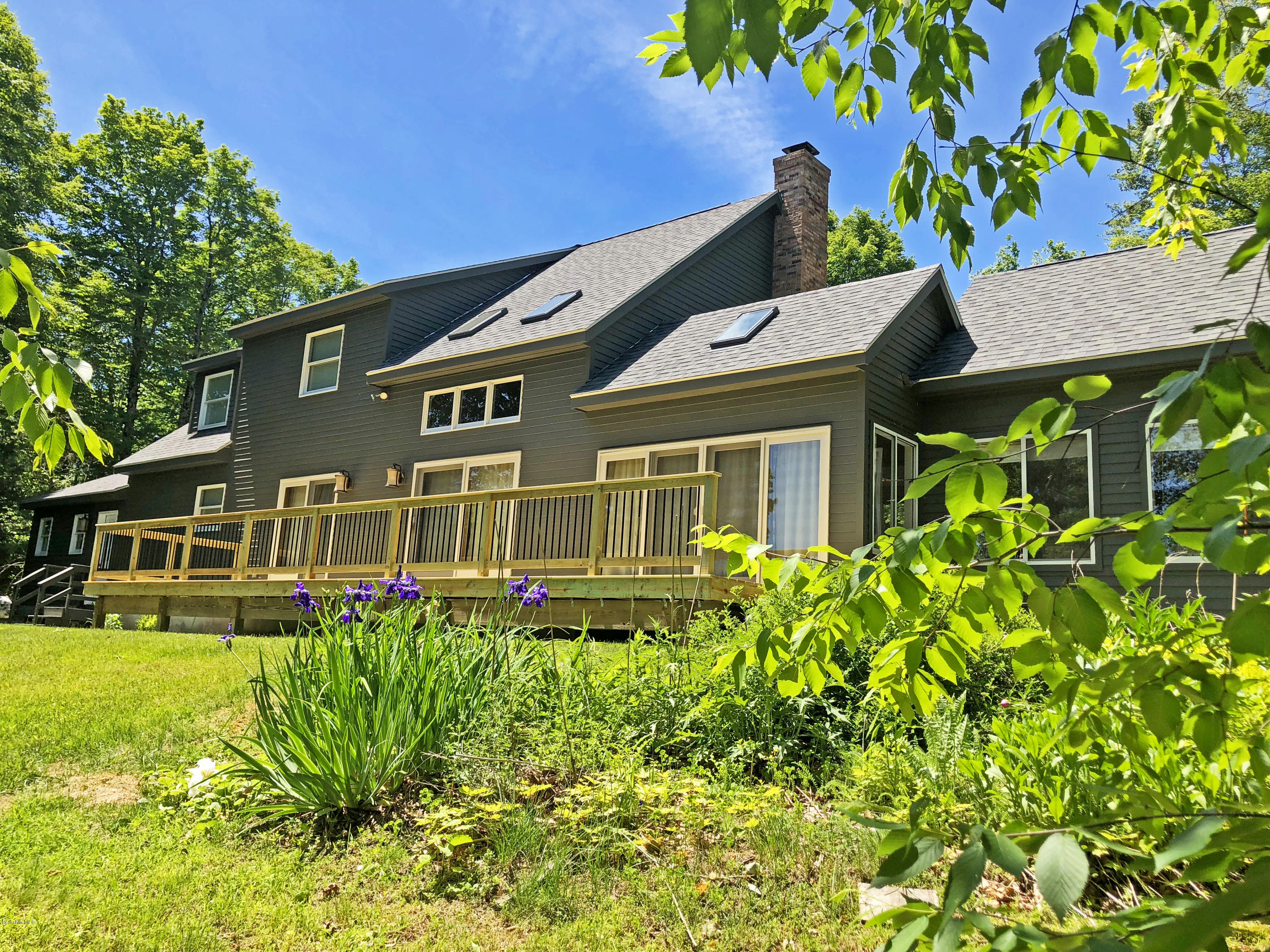 263 Harrington Road Otis, MA 01253 - Photo 3 of 33 a front view of a house with garden