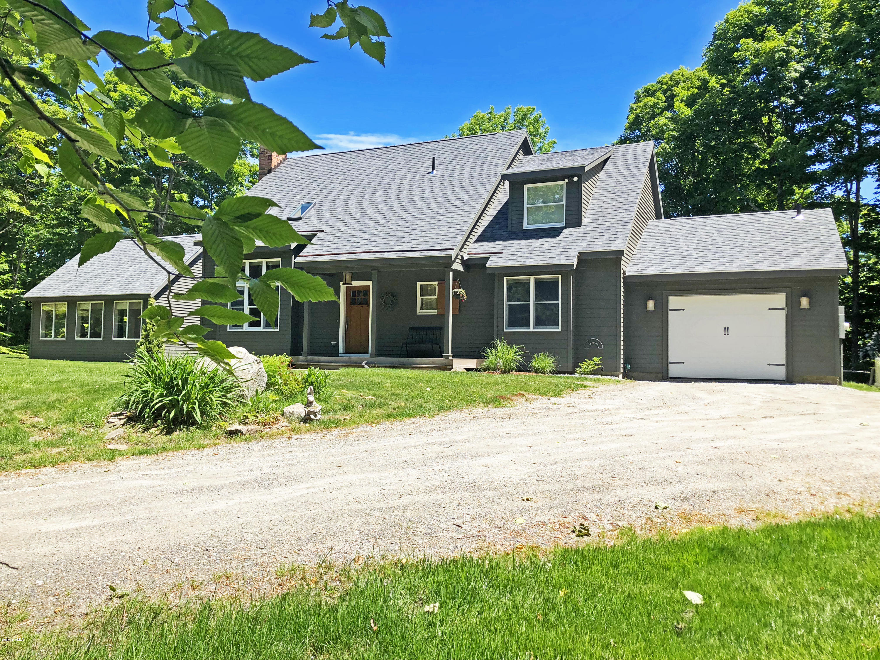 263 Harrington Road Otis, MA 01253 - Photo 29 of 33 a front view of a house with a garden and trees
