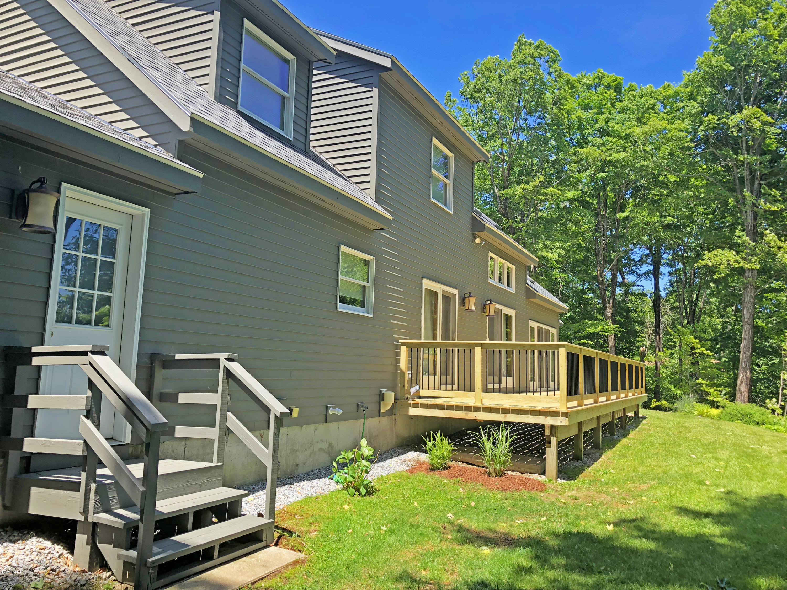 263 Harrington Road Otis, MA 01253 - Photo 8 of 33 a balcony with table and chairs