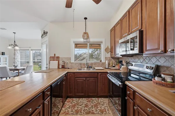 a kitchen with a sink stove and cabinets