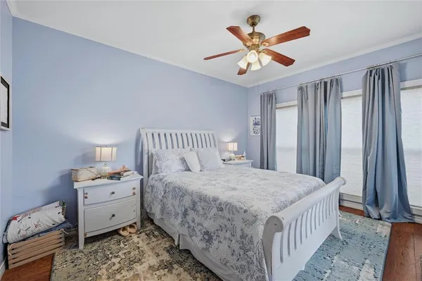 a bedroom with a large bed and a chandelier