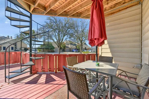 a view of a two chairs in the balcony