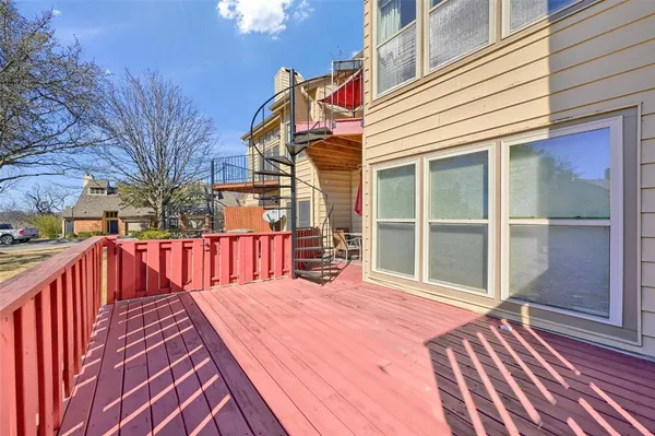 a view of balcony with wooden floor and outdoor seating