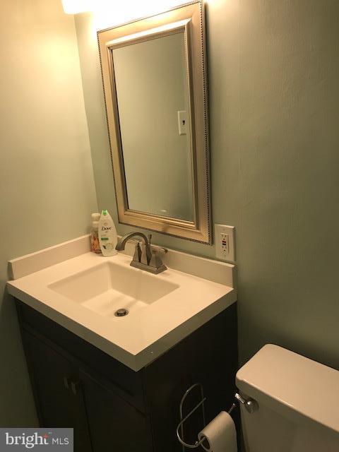 130 Slade Avenue, Unit 411 Baltimore, MD 21208 - Photo 11 of 18 a bathroom with a sink vanity and a toilet