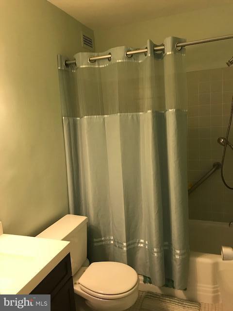 130 Slade Avenue, Unit 411 Baltimore, MD 21208 - Photo 12 of 18 a white toilet sitting next to a bathroom sink