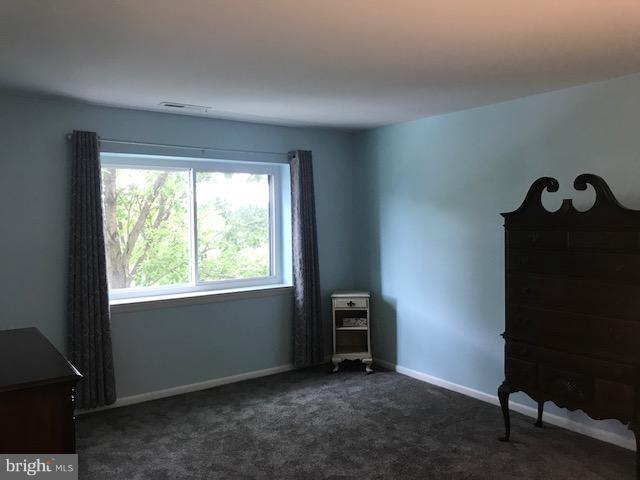 130 Slade Avenue, Unit 411 Baltimore, MD 21208 - Photo 13 of 18 a view of an empty room with a window