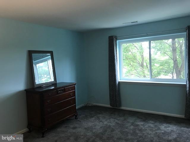 130 Slade Avenue, Unit 411 Baltimore, MD 21208 - Photo 14 of 18 a room with window and dresser