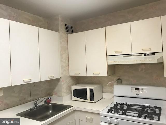130 Slade Avenue, Unit 411 Baltimore, MD 21208 - Photo 4 of 18 a kitchen with stainless steel appliances a stove and a refrigerator