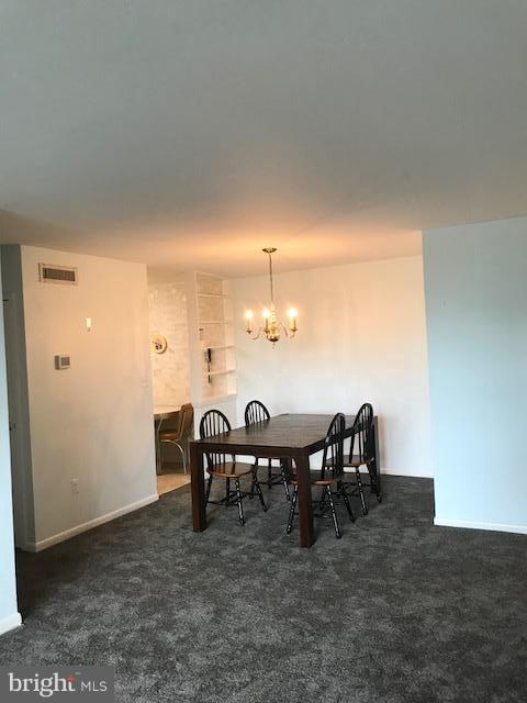 130 Slade Avenue, Unit 411 Baltimore, MD 21208 - Photo 7 of 18 a view of a dining room with furniture
