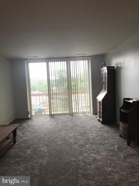 130 Slade Avenue, Unit 411 Baltimore, MD 21208 - Photo 9 of 18 a view of an empty room with a window