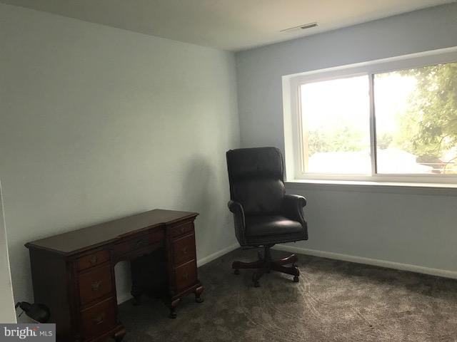 130 Slade Avenue, Unit 411 Baltimore, MD 21208 - Photo 10 of 18 a view of a workspace with furniture and a window