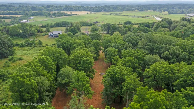 a backyard of a house with lots of green space and fountain