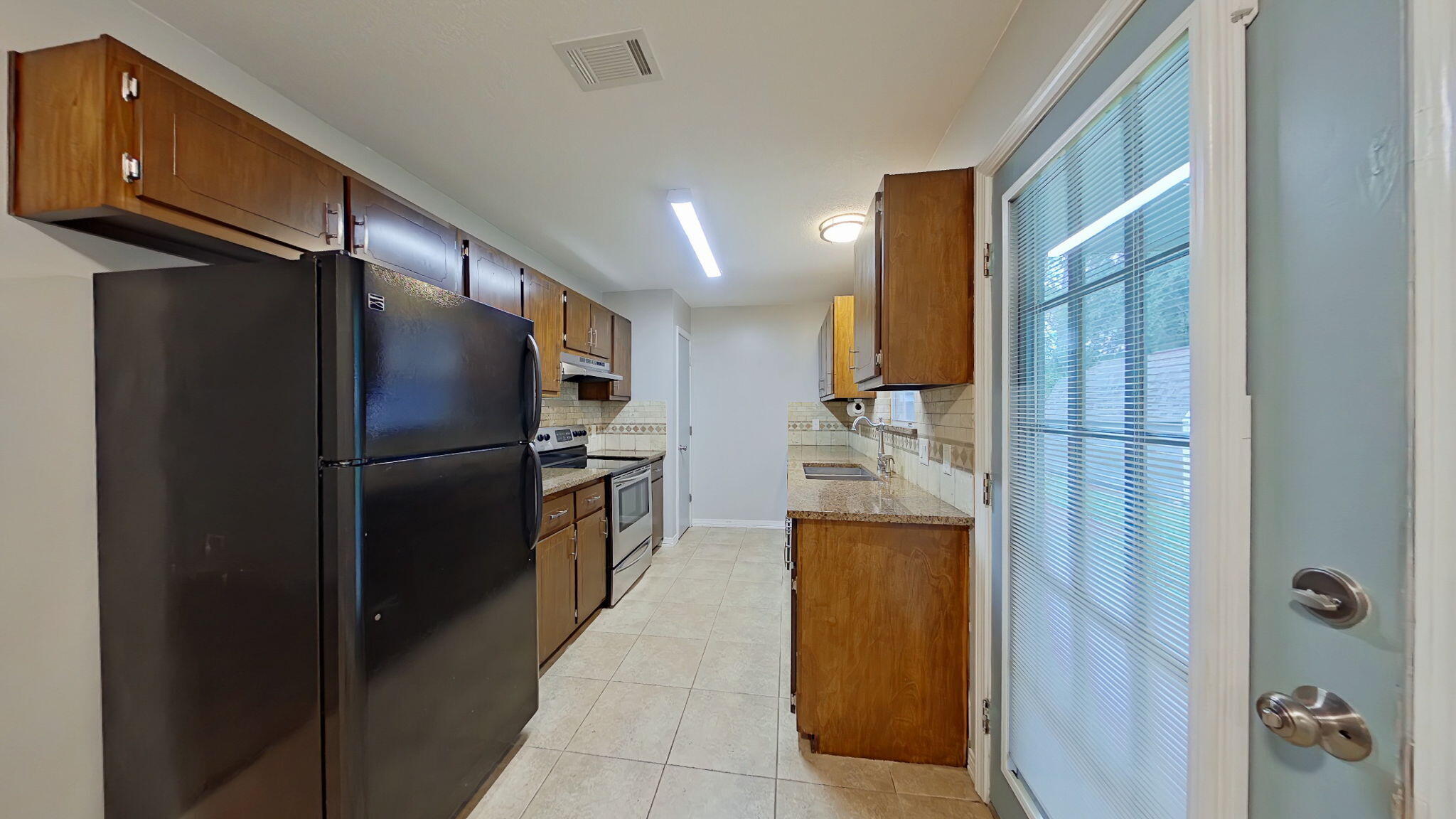 212 Water Oak Lane Crestview, FL 32539 - Photo 12 of 29 a kitchen with stainless steel appliances granite countertop a refrigerator and a stove