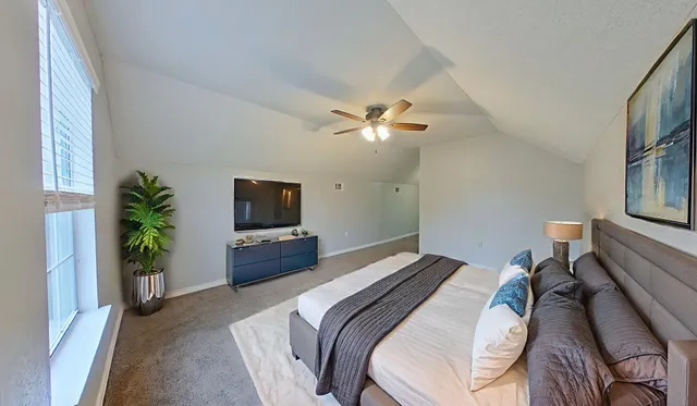 a bedroom with a bed and a television