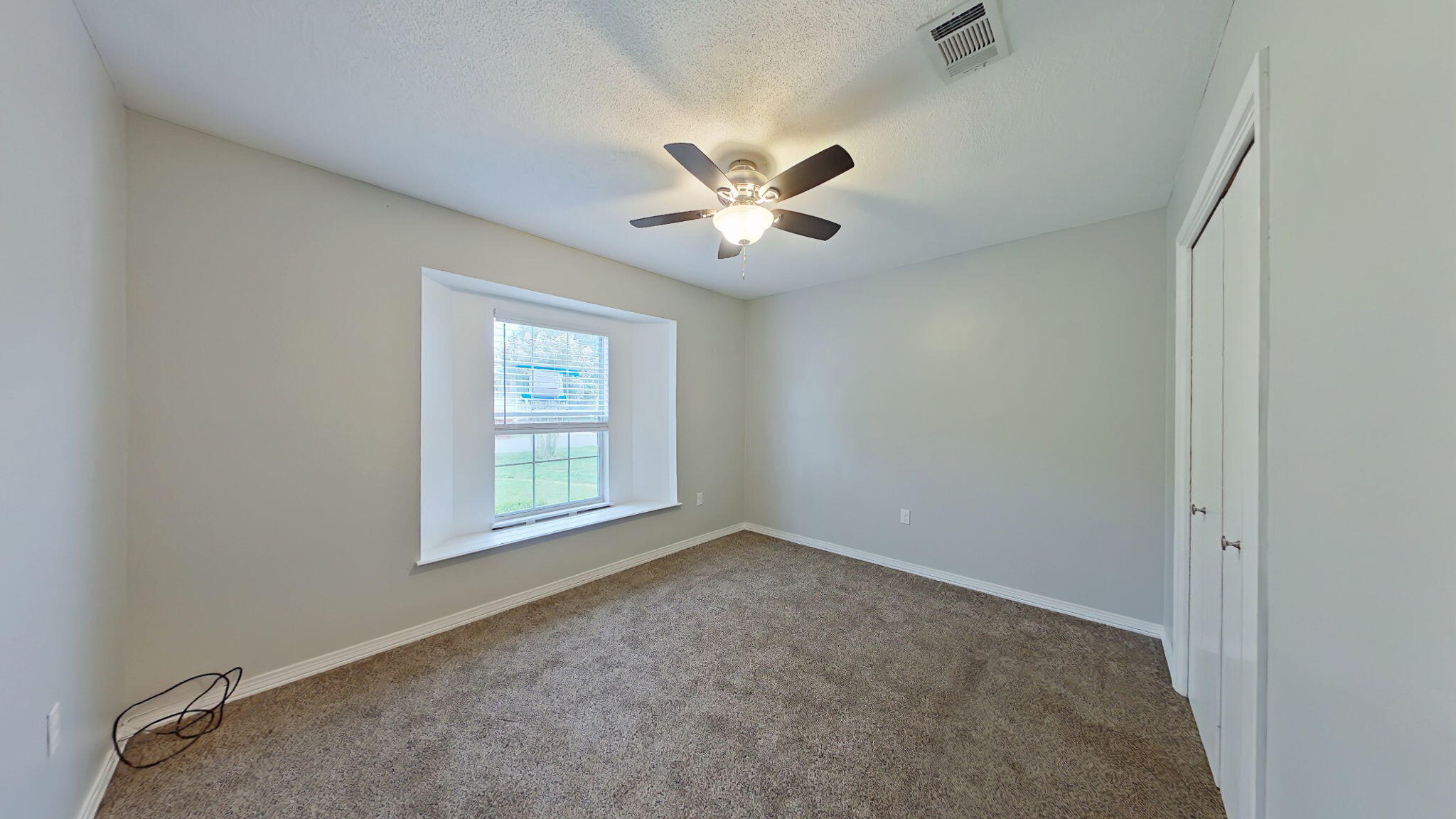 212 Water Oak Lane Crestview, FL 32539 - Photo 22 of 29 an empty room with a window and a fan